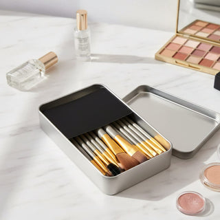 12-Piece Brush with Metal Box Set - A metal box set containing 12 makeup brushes with silver handles and gold detailing.