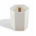 Noosa Hexagon Ceramic Candle - A white hexagonal ceramic candle with a wooden wick placed inside. It has a minimalist design.