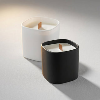 Premium Square Glass Candle - Two square candles in black and white glass containers, featuring wooden wicks, against a neutral background.