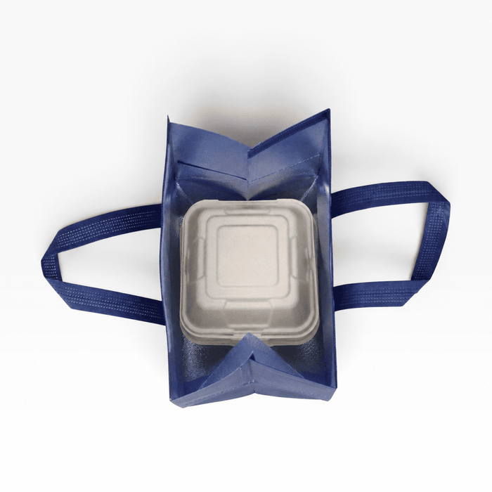 5L Insulated Reusable Bag - A navy insulated reusable bag with two handles, containing a square white food container inside. It has a logo on the exterior.
