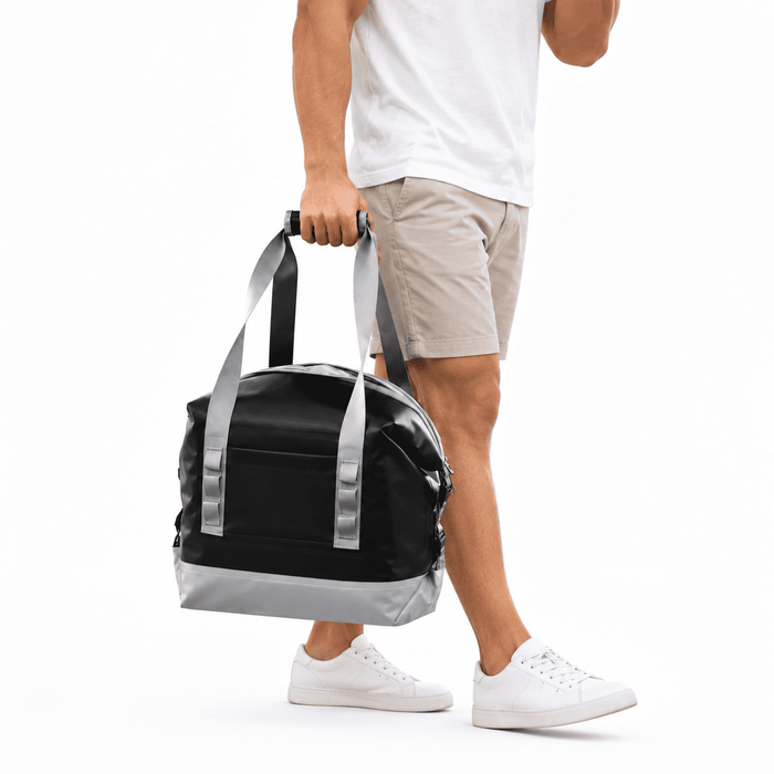 Premium 17L Foldable Cooler - A foldable cooler in black and silver, carried by a person in shorts and a white shirt, with a logo visible.