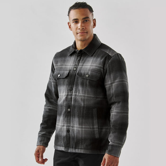Men's Highland Sherpa Lined Plaid Jacket - A men's black and grey plaid jacket with a Sherpa lining and button front, featuring two chest pockets and a logo.