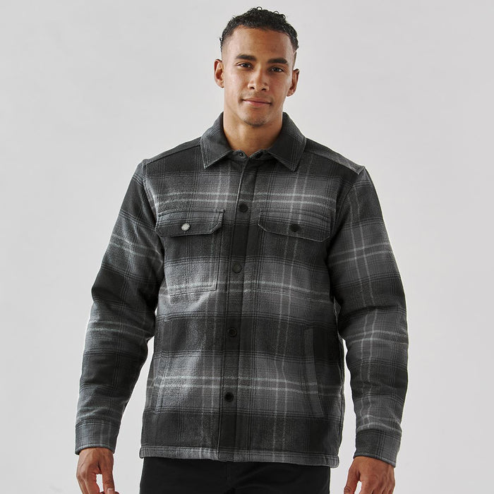 Men's Highland Sherpa Lined Plaid Jacket - A men's black and grey plaid jacket with a Sherpa lining and two chest pockets, featuring a logo on the front.