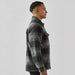 Men's Highland Sherpa Lined Plaid Jacket - A men's plaid jacket in black and grey with a Sherpa lining, featuring a front pocket and a classic collar.