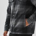 Men's Highland Sherpa Lined Plaid Jacket - A plaid jacket featuring a grey and black pattern, with a sherpa lining and front pockets. It has a logo.