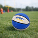 Mini Promotional Basketball - A mini basketball in blue and white resting on green grass, featuring a logo.