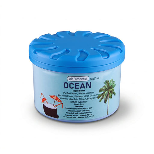 Air Freshener – Ocean - A blue air freshener container with a lid, labelled "Ocean," featuring tropical drink illustrations.