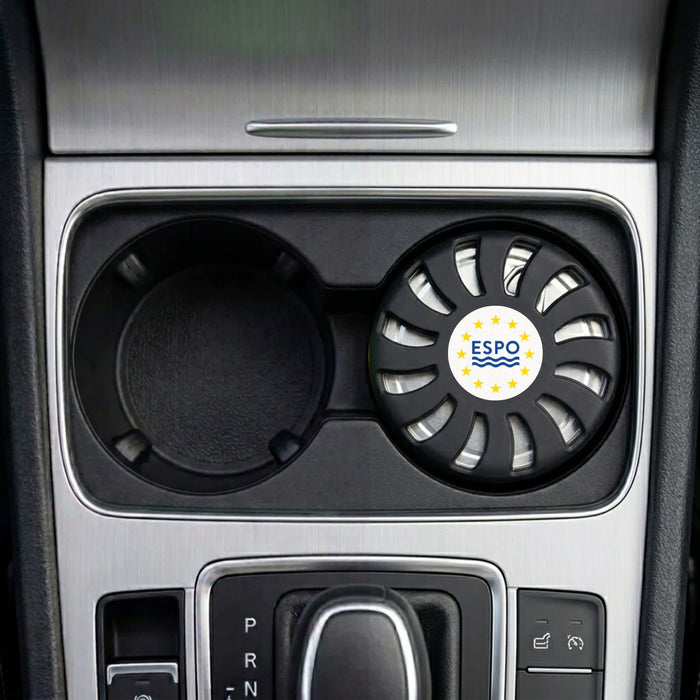 Air Freshener – New Car - An air freshener in a circular black holder, placed in a car cup holder, featuring a logo.