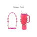 Woven Flower Tumbler Strap - A drink bottle with a pink and white woven strap featuring yellow flowers, along with a logo on the strap.