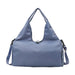 Duffle Bag With Yoga Mat Strap - A blue duffle bag with a yoga mat strap, featuring two carrying handles and a detachable shoulder strap.