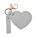 Heart-Shaped Compact Mirror with Keychain - A heart-shaped compact mirror in grey with a keychain attachment and a gold clasp.