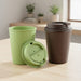 Karvo Kuppa – EcoBlend - A drink bottle set featuring a green cup and a brown tumbler with a lid, presented on a wooden table.