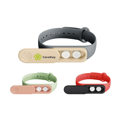 Medicine Box Wristband - A medicine box wristband with compartments in grey, green, peach, red, and black, featuring a logo.