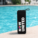 Sunrise Solar Speaker - A black portable speaker with a round logo, sitting by a blue pool.