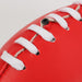 Mini Promotional Aussie Rules Ball - A red promotional Aussie Rules ball with white lacing and a smooth surface. It features a logo.