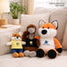 Plush Doll Basic Tank Top - Three plush dolls displayed on a sofa: a small fox in yellow, an emu in grey, and a large orange fox, all wearing black tank tops.