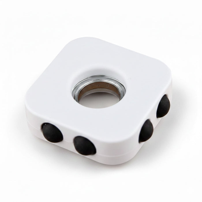 Decompression Finger Spinner - A white decompression finger spinner with three black buttons and a central bearing. It has a smooth, square design.