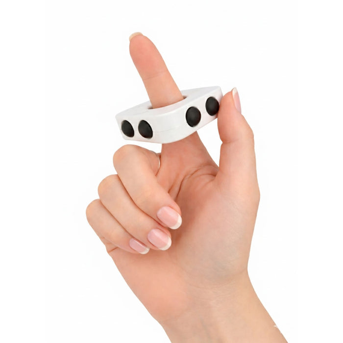 Decompression Finger Spinner - A white finger spinner held between fingers, featuring three black buttons on its surface.