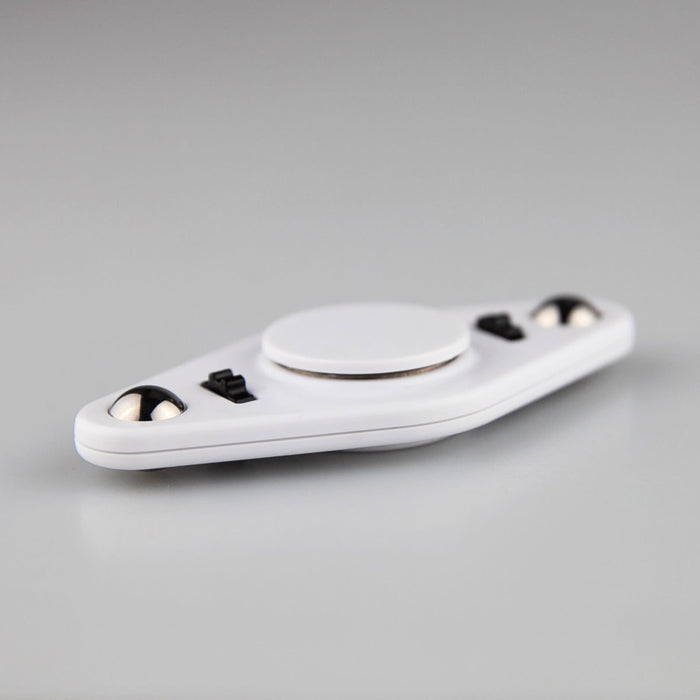Vibro Fidget Spinner - A white fidget spinner with a central circular area and black accents, featuring two smooth spinning balls.
