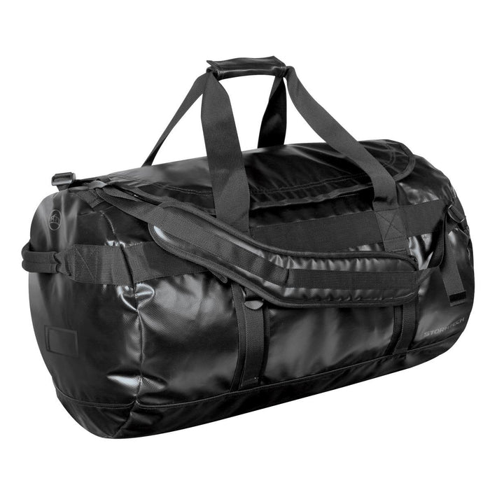 Stormtech Gear Bag Large - A large black duffle bag with sturdy handles and adjustable straps, featuring a logo.