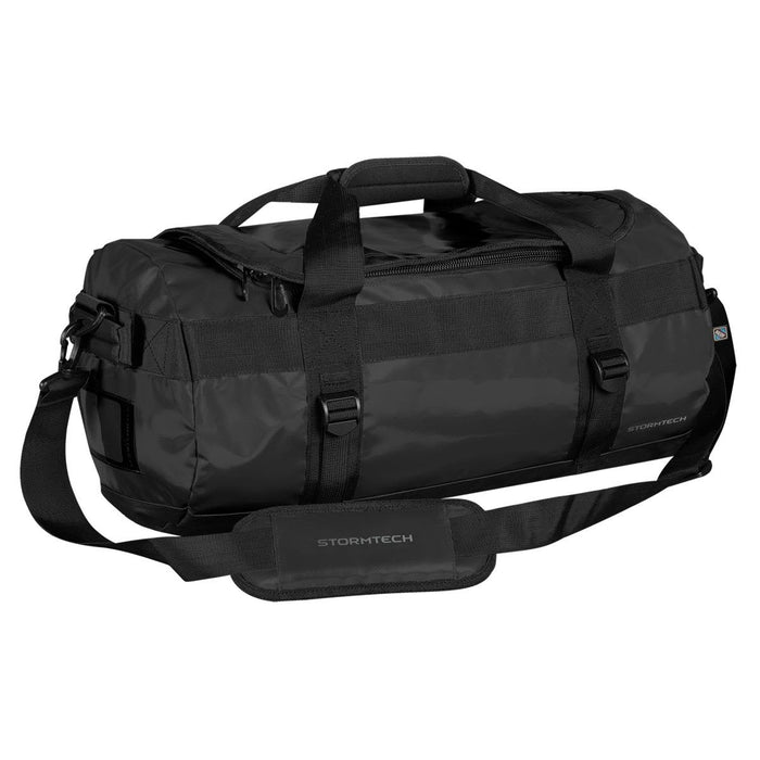 Stormtech Gear Bag Small - A black duffle bag with adjustable straps and a logo, featuring a zippered opening and sturdy handles.