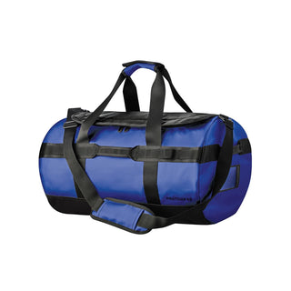 Nautilus Waterproof Duffle 35 - A waterproof duffle bag in blue and black, featuring adjustable straps and a logo on the side.