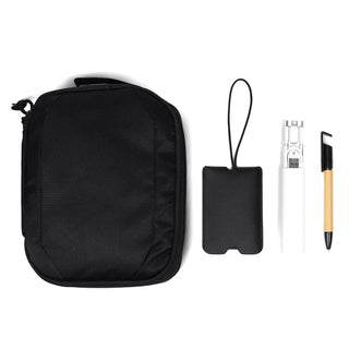Travel Pack - A black travel pack with a drink bottle, a pen, a cardholder, and a small strap accessory.
