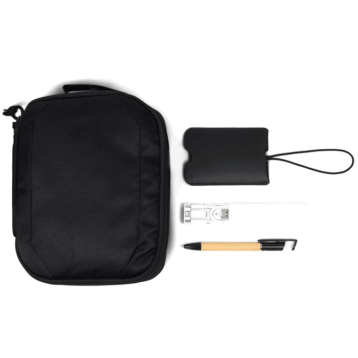 Travel Pack - A black travel pack containing a pouch, pen, USB, and a card holder, featuring a simple design with a logo.