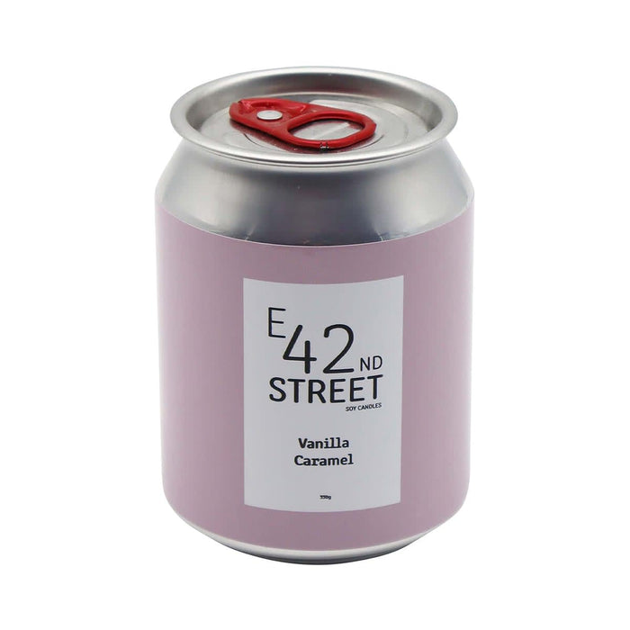 Mini East 42nd Street Can Candle - A pink can-shaped candle with a silver lid, featuring a label for 'Vanilla Caramel' fragrance and a logo.