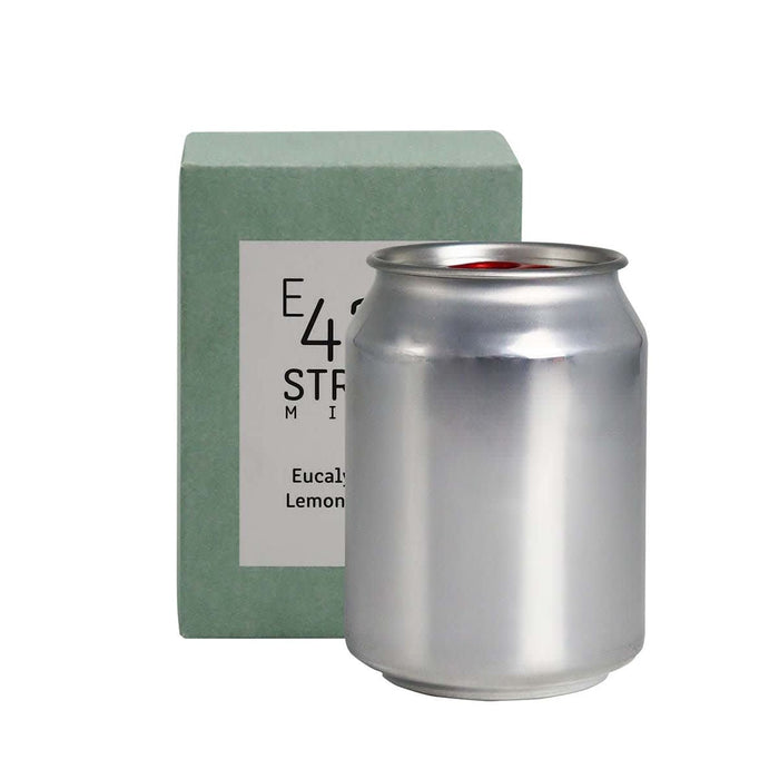 Mini East 42nd Street Can Candle - A silver can candle with a green packaging box, featuring a logo. The scent is eucalyptus and lemon.
