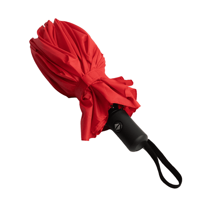 Poppins Umbrella - A red umbrella with a black handle, featuring a logo on the handle, secured with a strap.