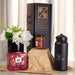 Festive Essentials Set - A festive essentials set featuring a black drink bottle, a candle jar, a gift box, and a flower arrangement.