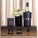 The Entertainer Set - A drink bottle in a black cooler, alongside a box of brittle and a black vase with white flowers.