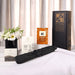 The Blunt Umbrella All Weather Set - A black umbrella set displayed with assorted product boxes and a floral arrangement on a table.
