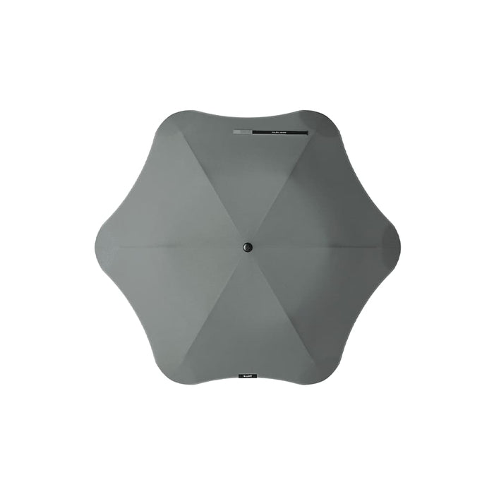The Blunt Umbrella All Weather Set - A grey umbrella with a unique shape, featuring a central button and a simple, modern design.