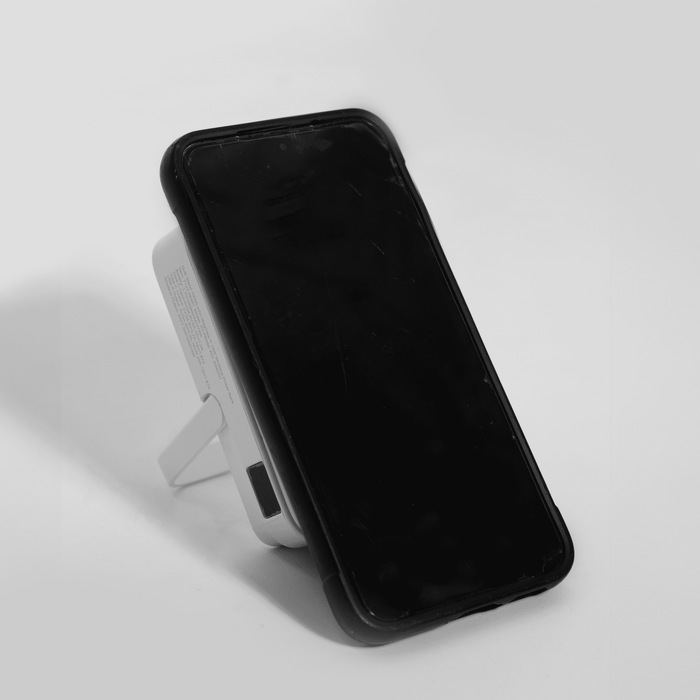 The Mellany 15W Wireless Charging Powerbank 10,000mAh - A wireless charging power bank in white, featuring a stand and a black face. It has a logo on the side.