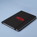 Space A5 Notebook - A black A5 notebook with a logo on the cover and an elastic closure, set against a light blue background.