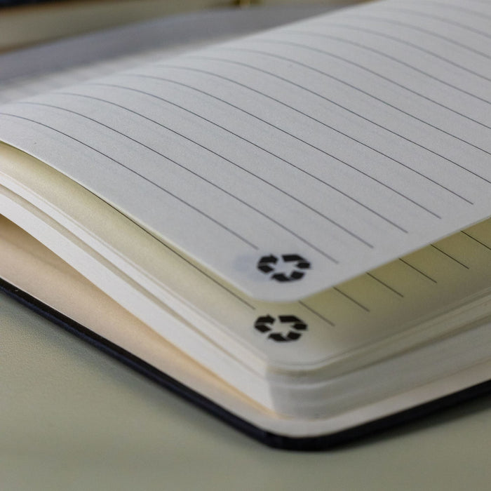 Discovery A5 Notebook - An A5 notebook with lined pages, featuring a black cover and a recycling symbol on the tabs.