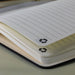 Discovery A5 Notebook - An A5 notebook with lined pages, featuring a black cover and a recycling symbol on the tabs.