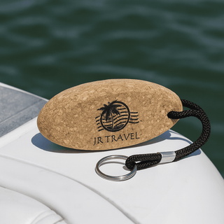Cork Floating Keychain - A cork keychain in an oval shape with a black rope and a keyring, featuring a logo with a palm tree.