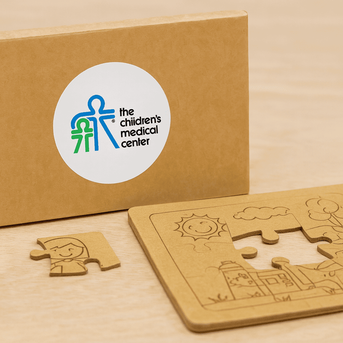 Kids Jigsaw 2 Puzzle Set - A natural wood jigsaw puzzle set with a puzzle piece and a brown box featuring a logo.