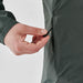 Women's Pacifica Full Zip Jacket - A hand adjusts the drawstring of a women's full zip jacket in green, featuring a logo on the fabric.