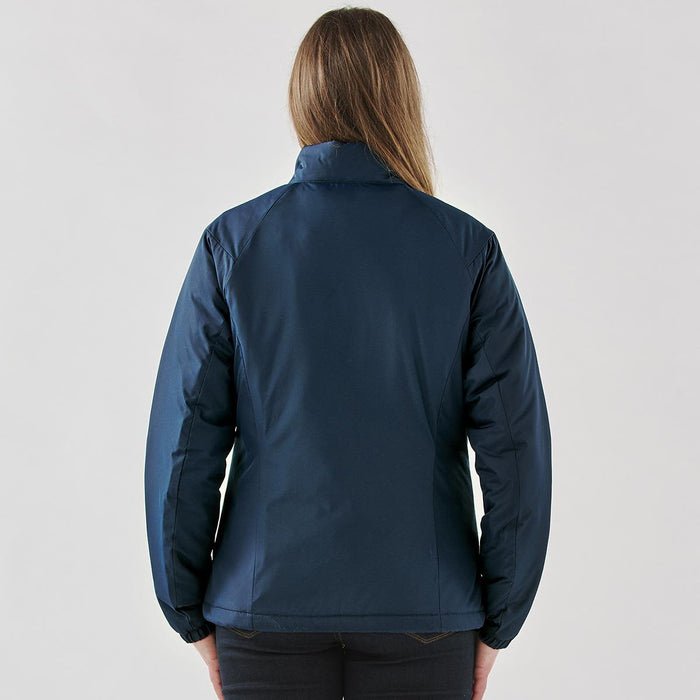 Women's Pacifica Thermal Jacket - A woman wearing a navy blue thermal jacket, viewed from the back. The jacket features a collar and has a logo.