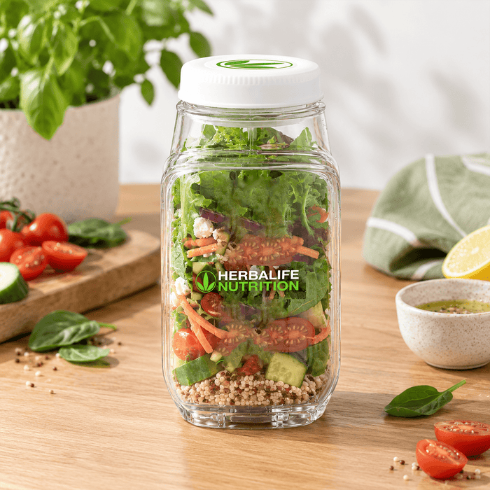 Go Salad Jar - A glass salad jar filled with fresh vegetables, including lettuce, tomatoes, and cucumbers, featuring a logo.