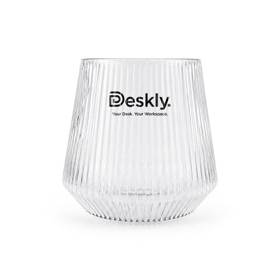 Velora Tumbler by The Line Edit. - A clear glass tumbler with ribbed texture and a logo at the front.