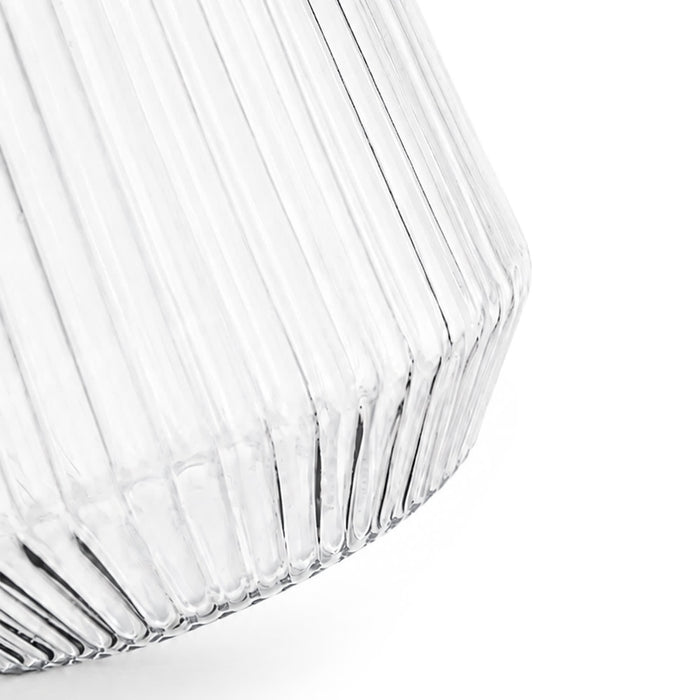 Velora Tumbler by The Line Edit. - A clear glass tumbler with a ribbed design, featuring a tapered base and a smooth rim.