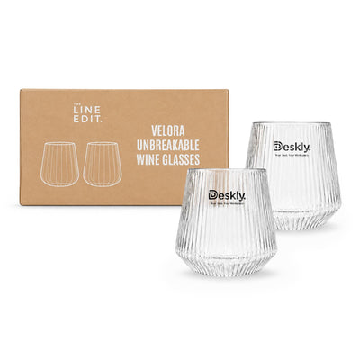 Velora Tumbler Gift Set by The Line Edit. - A set of two clear, unbreakable wine glasses with a ribbed design, packaged in a boxed set. The box features branding.
