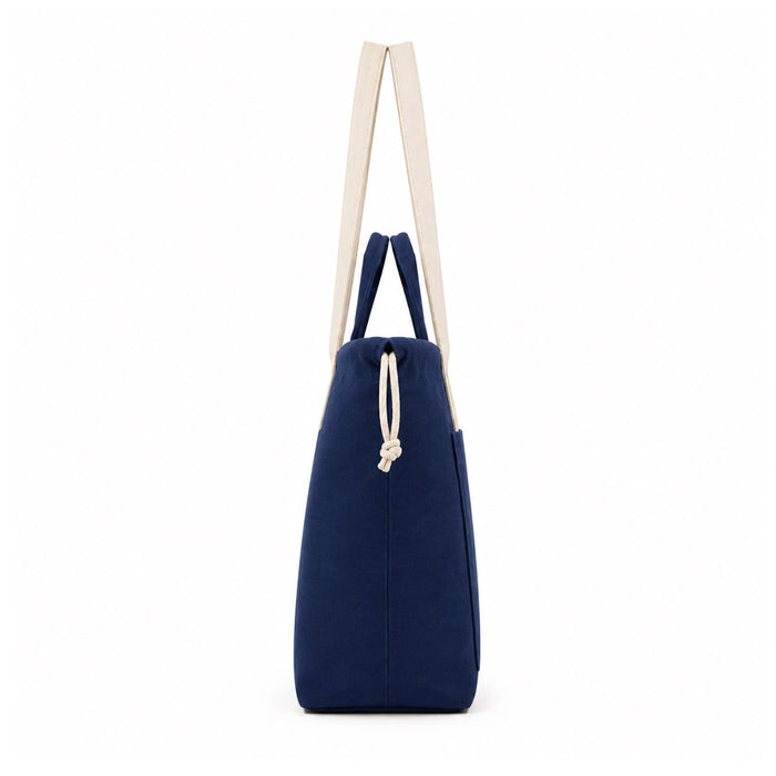 Darby Tote Bag - A navy tote bag with cream handles and a drawstring closure, featuring a subtle logo.