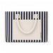 Hampton Tote Bag by The Line Edit. - A striped tote bag featuring navy and cream colours, with a flat pocket and sturdy handles. It has a logo.