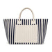 Hampton Tote Bag by The Line Edit. - A navy and cream striped tote bag with two sturdy handles and a front pocket. It features a branding logo.